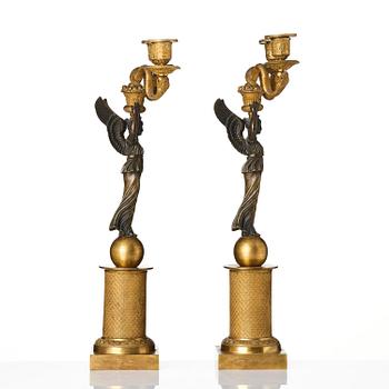 A pair of gilt and patinated bronze Empire-style two branch candelabra, later part 18th century.