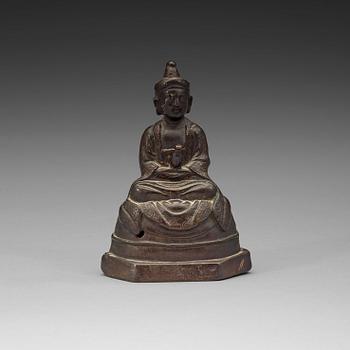 154. A seated bronze figure of a monk, Ming dynasty (1368-1644).