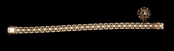 ARMLÄNK MED BERLOCK, 18 k guld samt cabochonslipade stenar. Segir, Köping, 1962. Vikt ca 25 g.