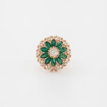 An marquise cut emerald and brilliant cut diamond ring.