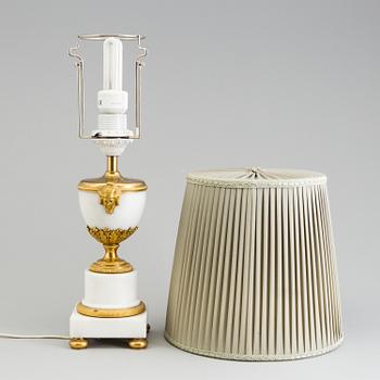 A late 19th century French Louis XVI-style marble and brass table lamp.