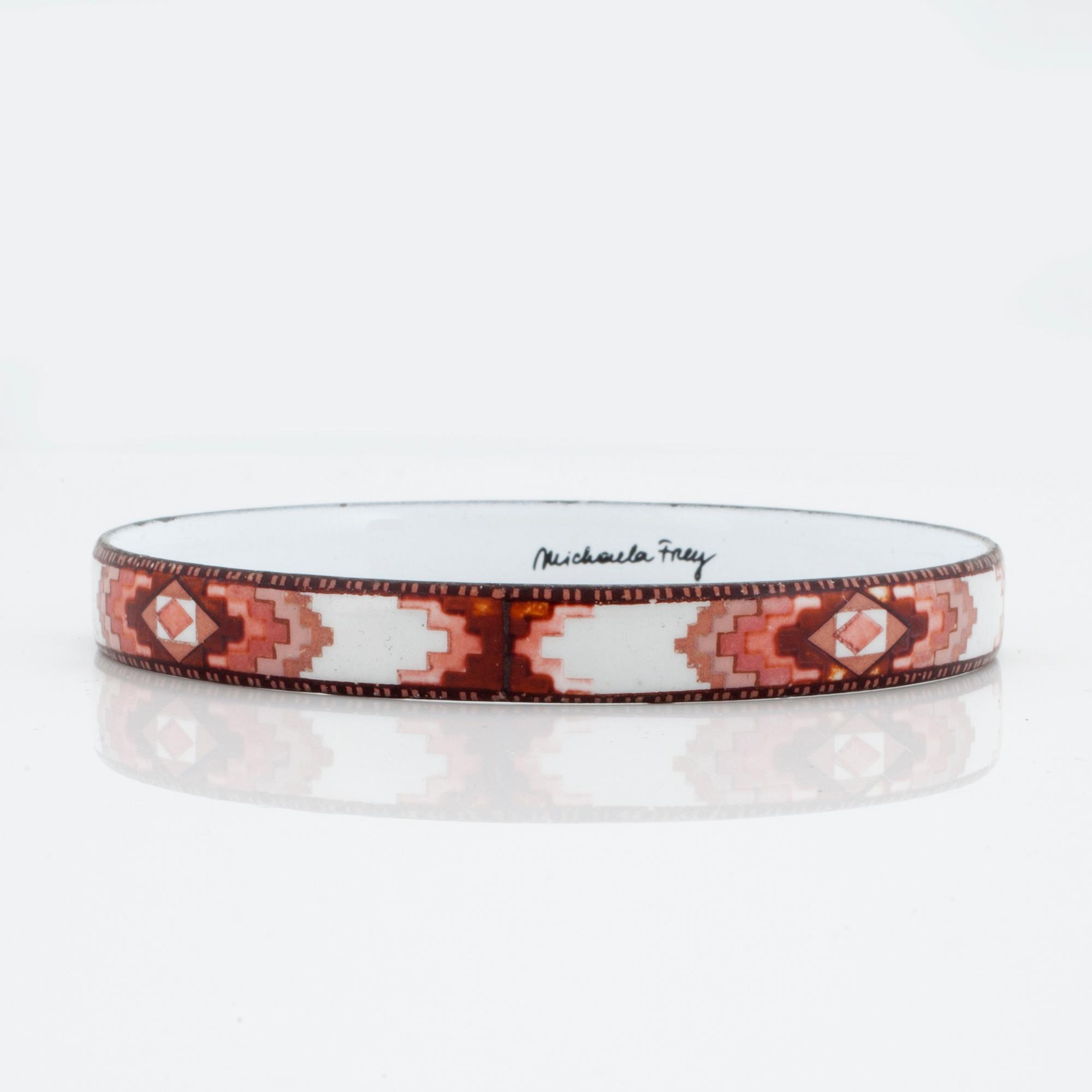 A bangle by Michaela Frey with multi-coloured enamel decoration.