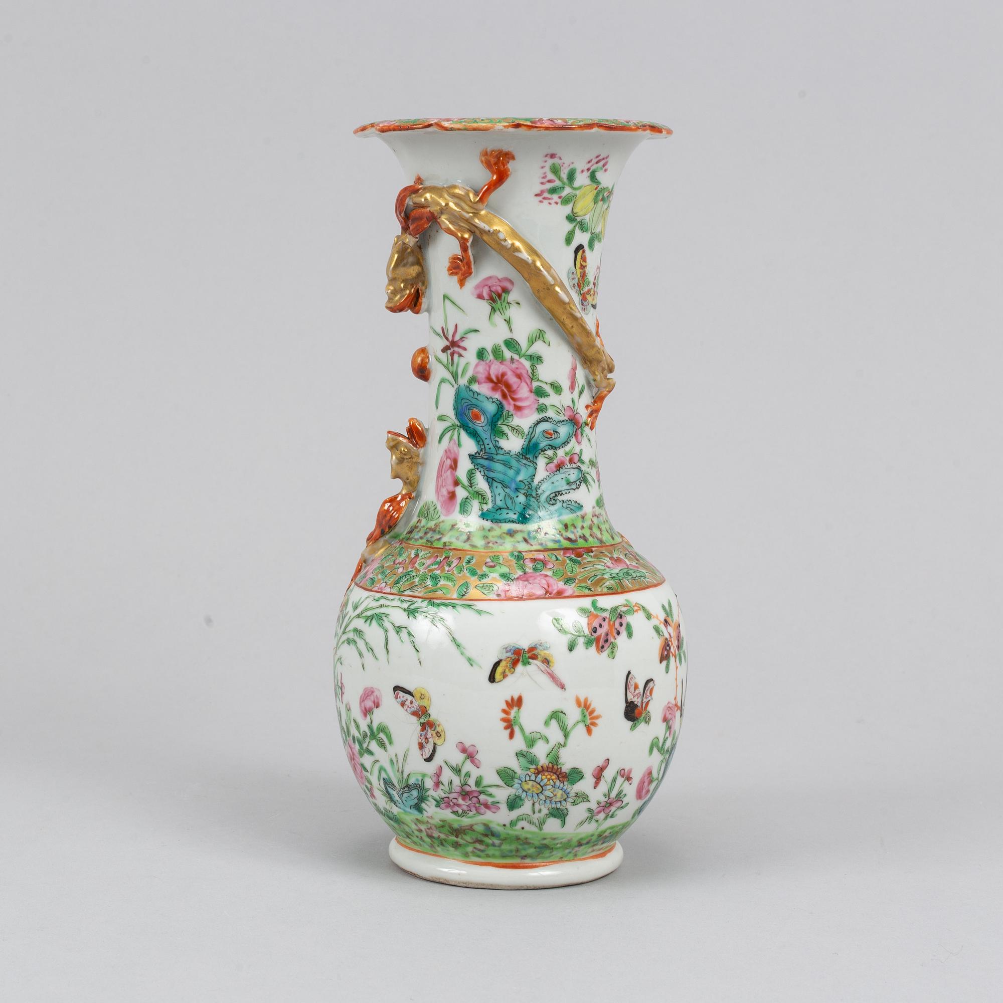 A pair of famille rose Canton table lamps and a vase, Qing dynasty, 19th Century.