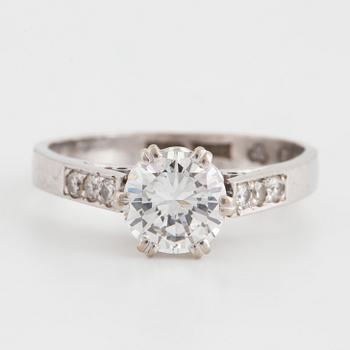 A round brilliant-cut diamond ring.