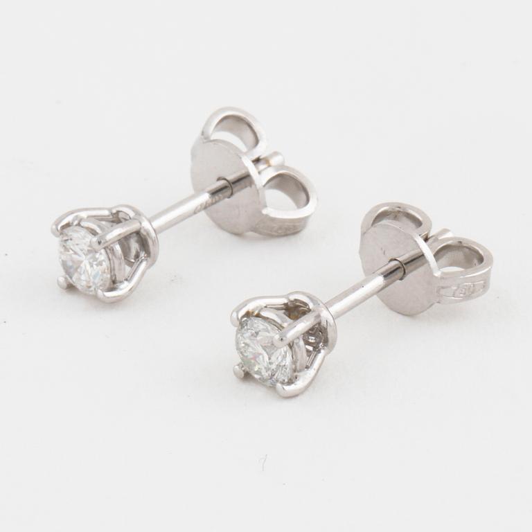 A pair of brilliant cut diamond earrings.