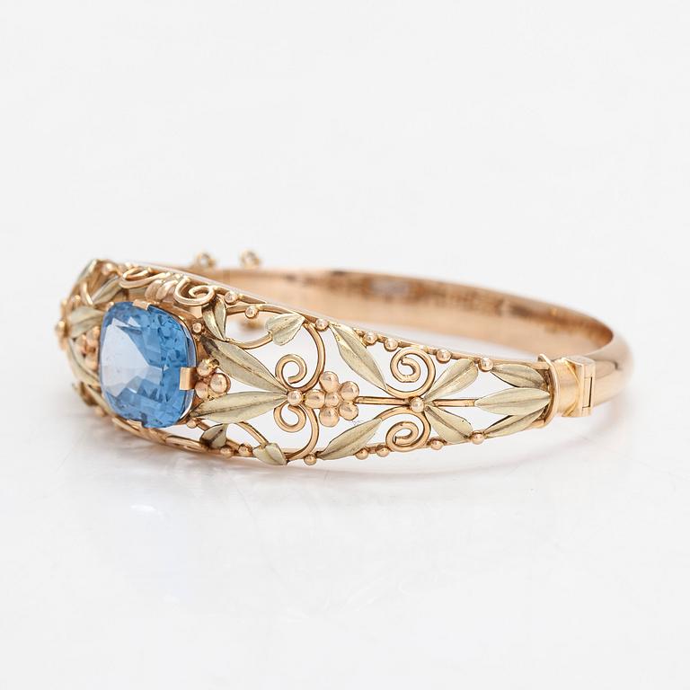An 14K gold bangle with a synthetic spinel, Auran Kultaseppä, Turku.