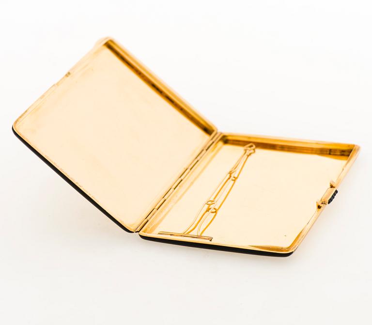 A Cartier Art Deco cigarette case in 18K gold with black enamel and set with sapphires.