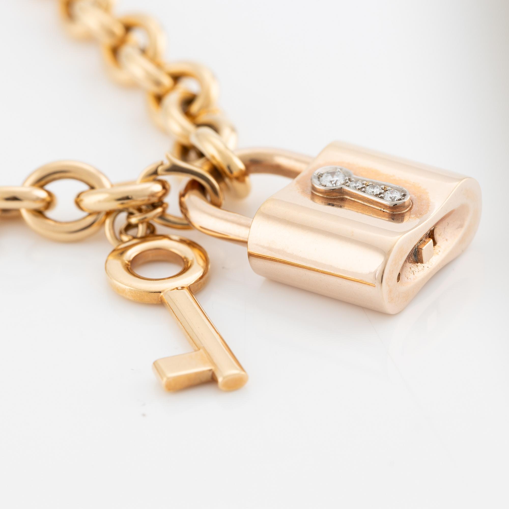 Collier, 18K guld, Gübelin, med 
berlock/hänge i form av lås Gübelin med briljantslipade diamanter.