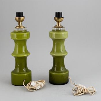 A pair of pea green glass 20th century table lamps.