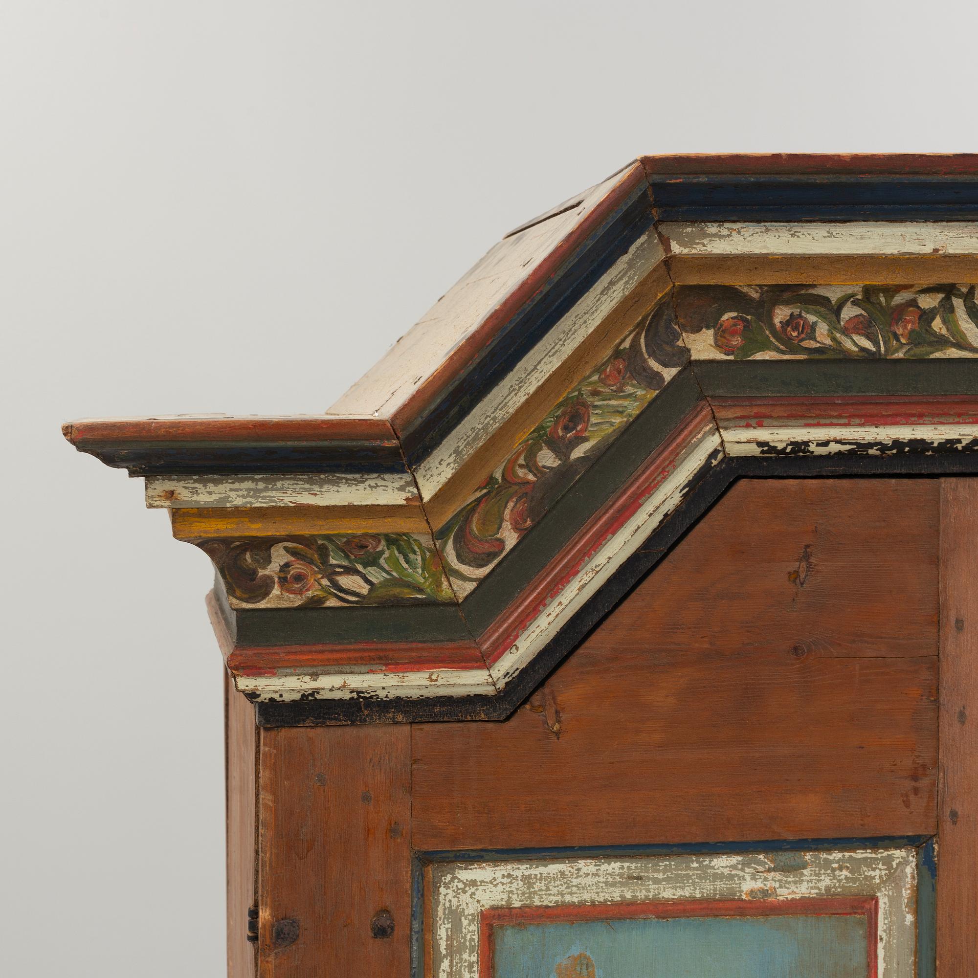 A Swedish polychrome.-painted cabinet, presumably from Halland, dated 1805.