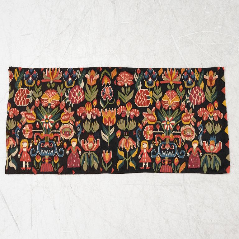 A carriage cushion, "Urnor och par", tapestry weave, ca 96 x 48,5 cm, Scania (Sweden), 19th century.