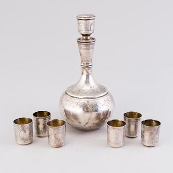 A Russian silver carafe with six cups, assay master's mark Anatoly Apollonovich Artsibashev / A. Romanov, Moscow 1889.