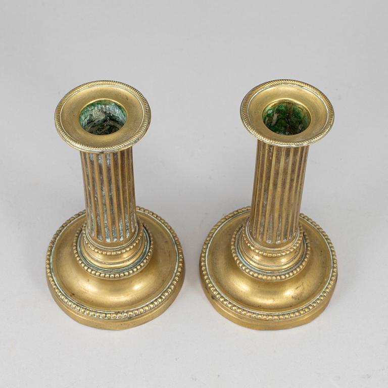 A pair of Louis Seize bronze candlesticks.