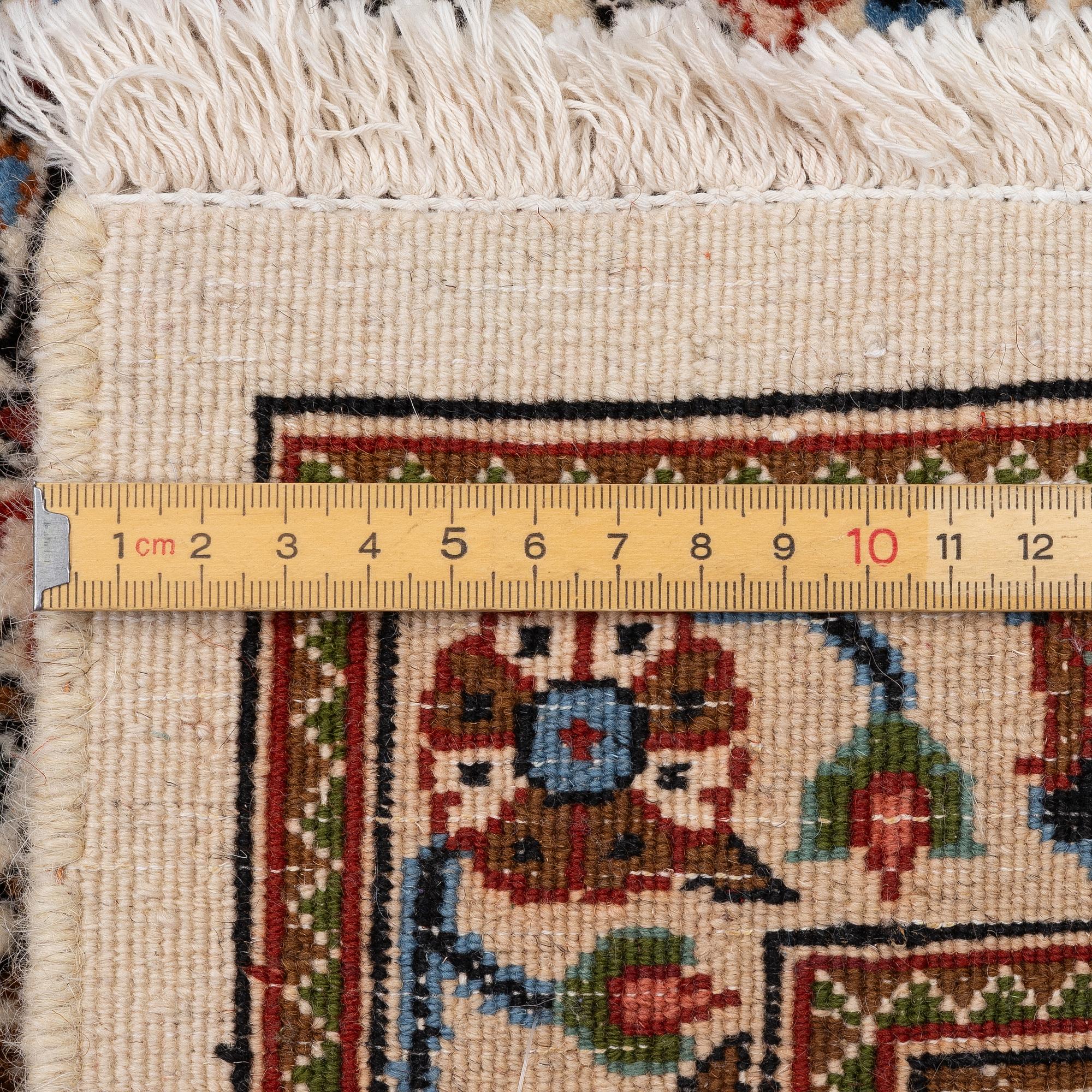 A Moud carpet, part silk, approx. 285 x 195 cm.