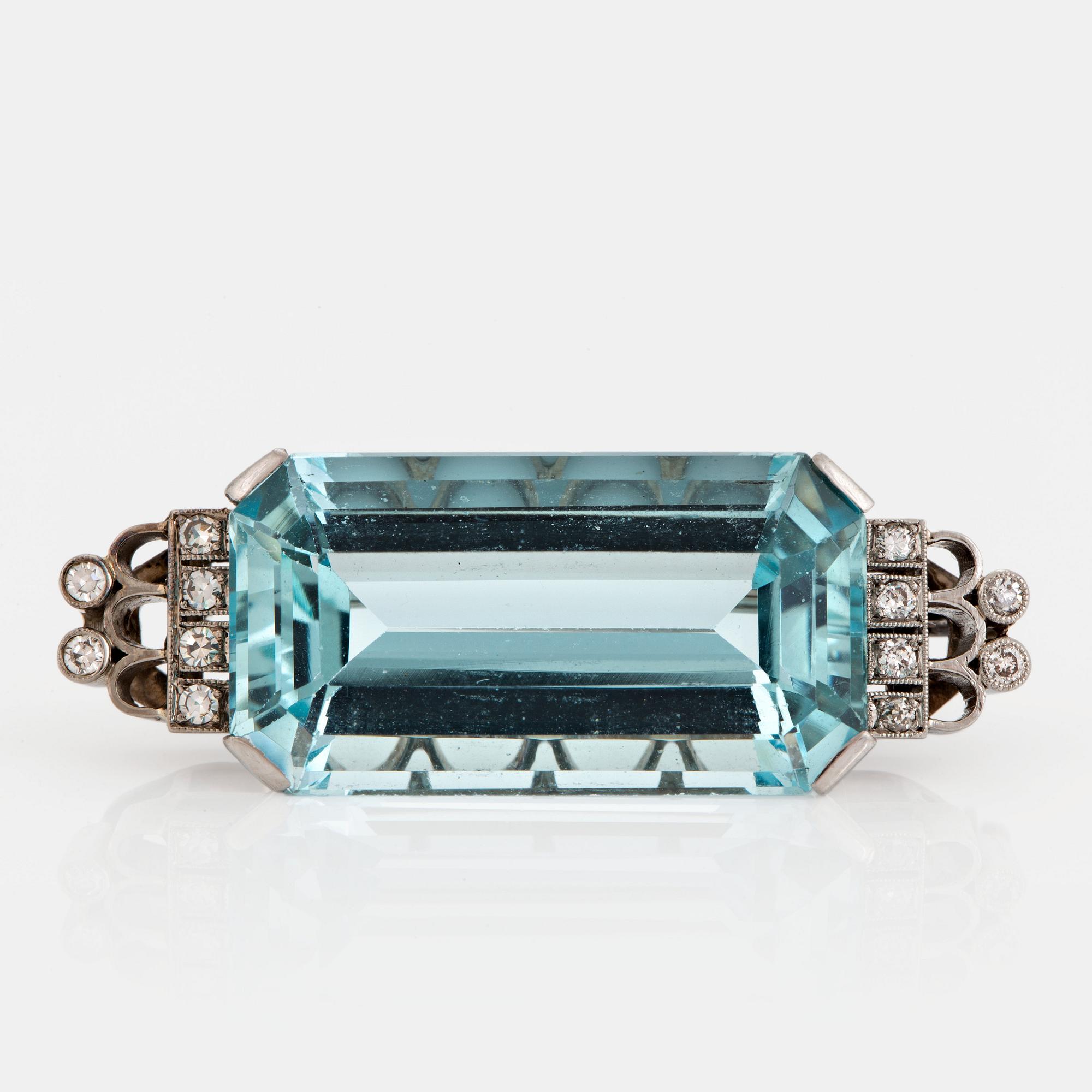A CF Carlman brooch in 18K white gold set with a faceted aquamarine and eight-cut diamonds.