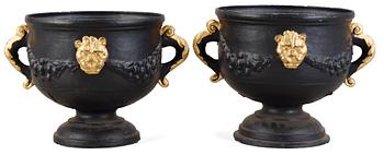 623. A pair of Baroque style 19th century iron cast garden urns.