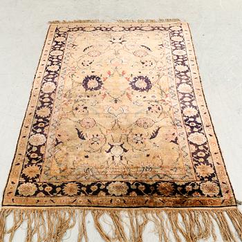 A semiantique Turkish silk carpet ca 183x122 cm.