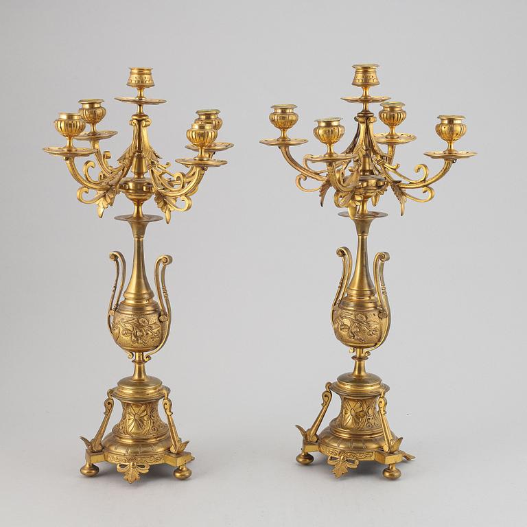 A pair of late 19th century brass candelabra for five candles.