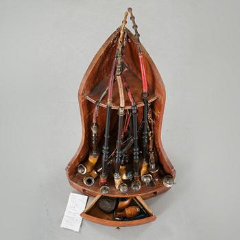 A 19th century pipe-rack with ten pipes and accessories.