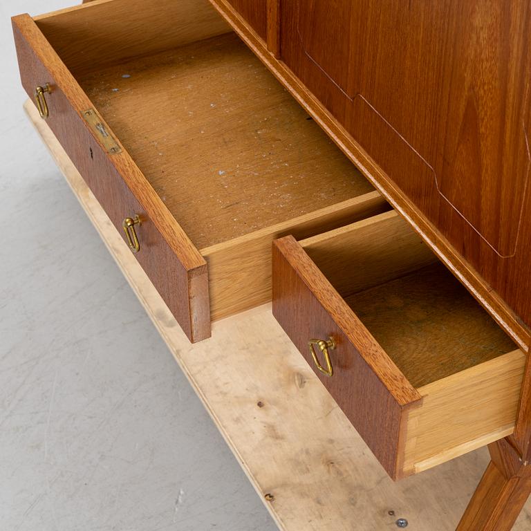 A teak-veneered mid 20th century sideboard.