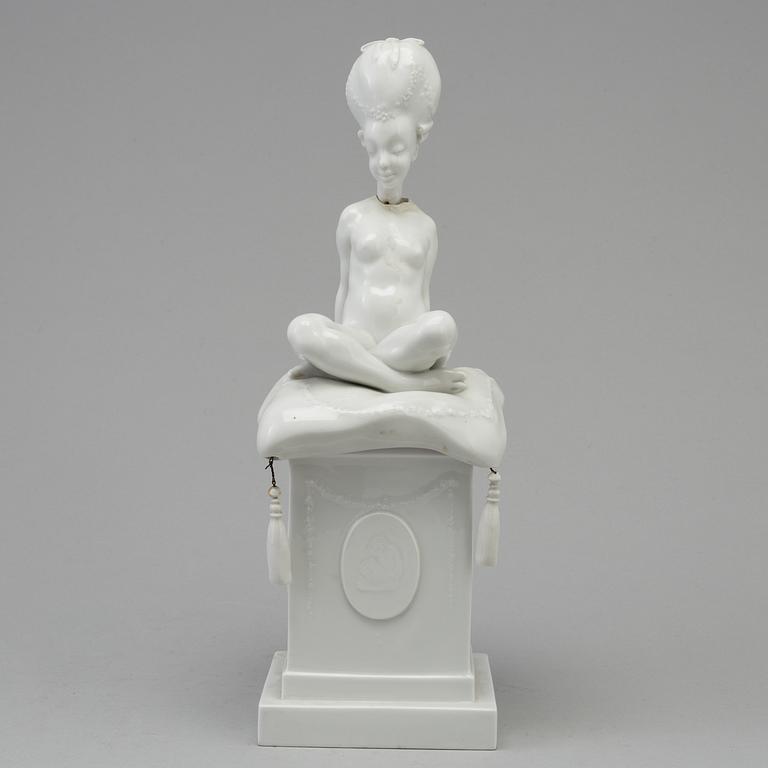 A white glazed Royal Copenhagen porcelain nodding head figure, Denmark, early 20th Century. Not first quality.
