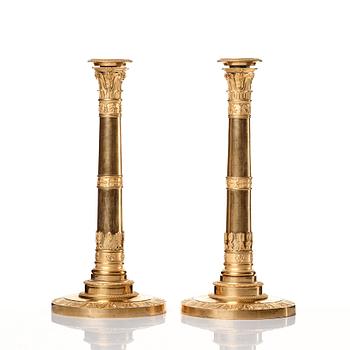 A set of four Empire presumably Russian candlesticks in gilded bronze.