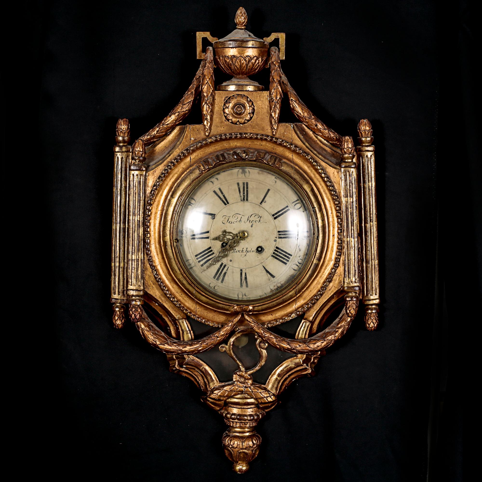 A Gustavian wall hanged clock, dial marked "Jacob Kock Stockholm", maded in the second half of the 18th century.