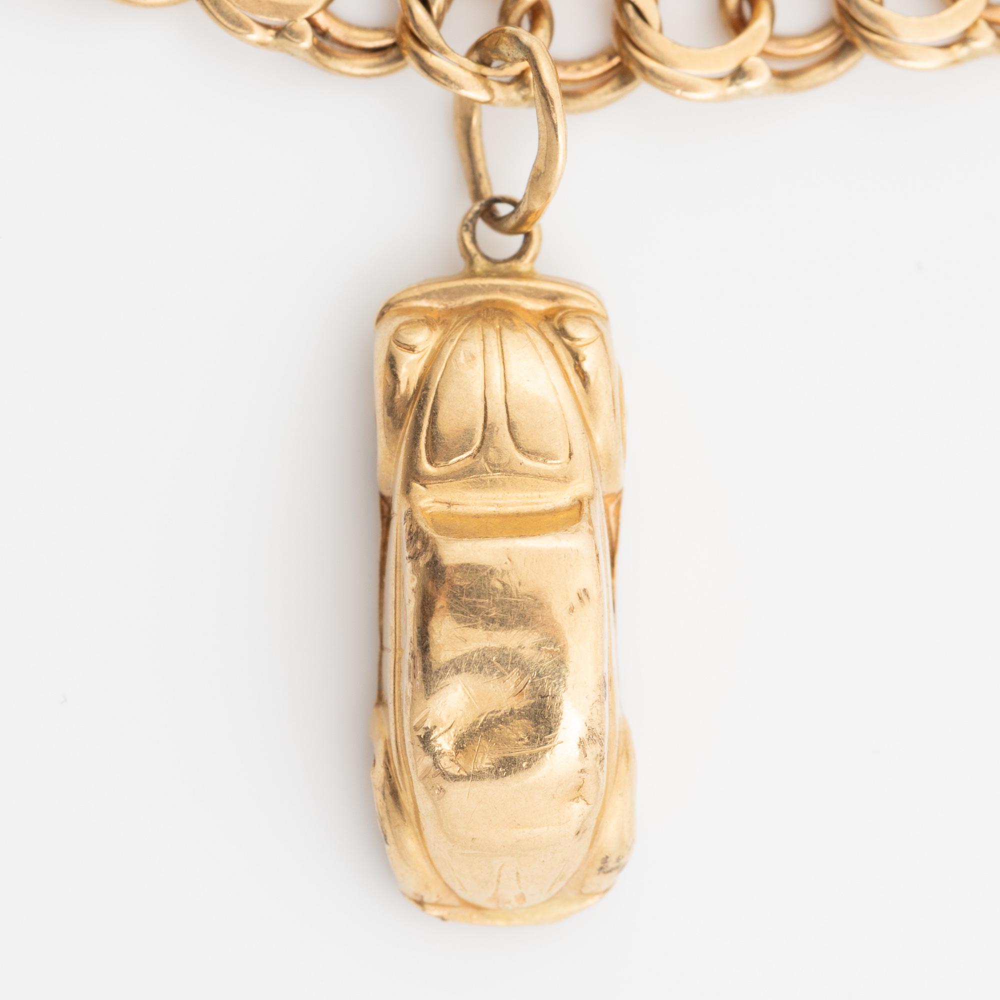Bracelet, 18K gold bismarck link. With charms.