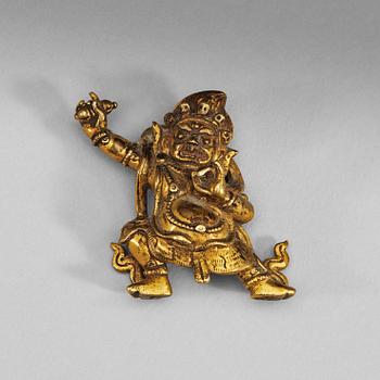 87. A Sinotibetan gilt bronze miniature standing figure of a Dharmapala, presumably 18th Century.