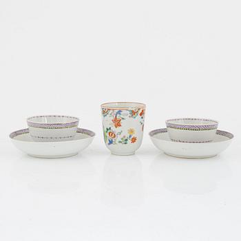 A pair of Chinese famille rose cups with saucers and a cup, Qing dynasty, 18th century.