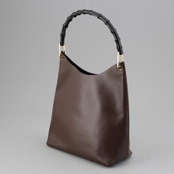 Gucci, a leather bag.