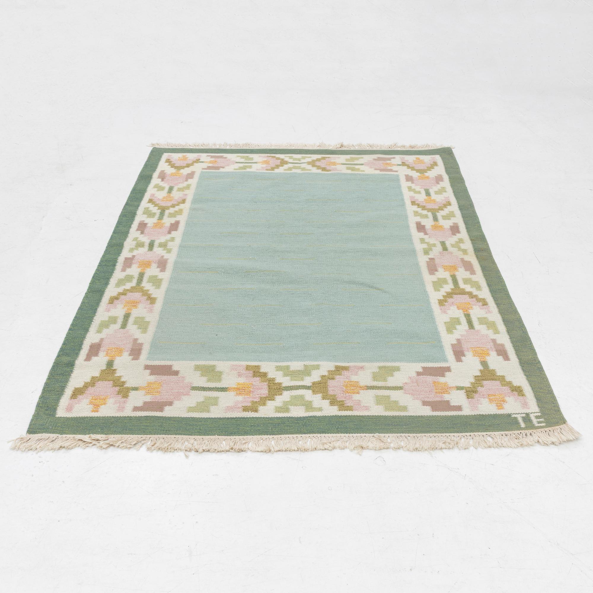 A flat weave carpet, signed TE, c. 224 x 126 cm.