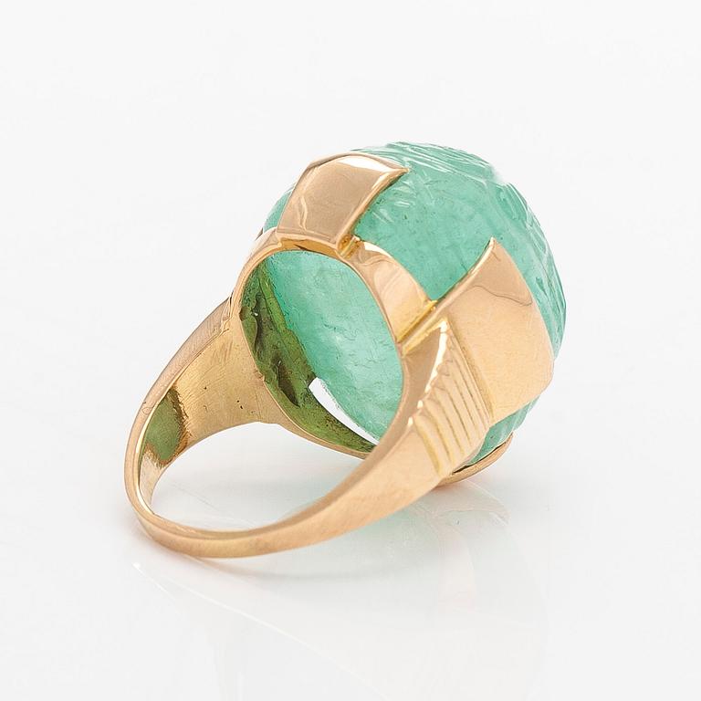 An 18K gold ring with a cabochon-cut emerald, import-stamped A. Tillander.