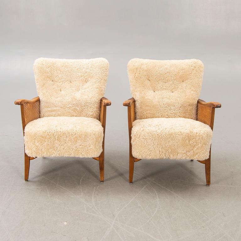 A pair of 1940/50s cheep skin armchairs.