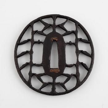 An iron open work, sukashi, Japanese tsuba, Edo (1603-1868). In a kiri box.