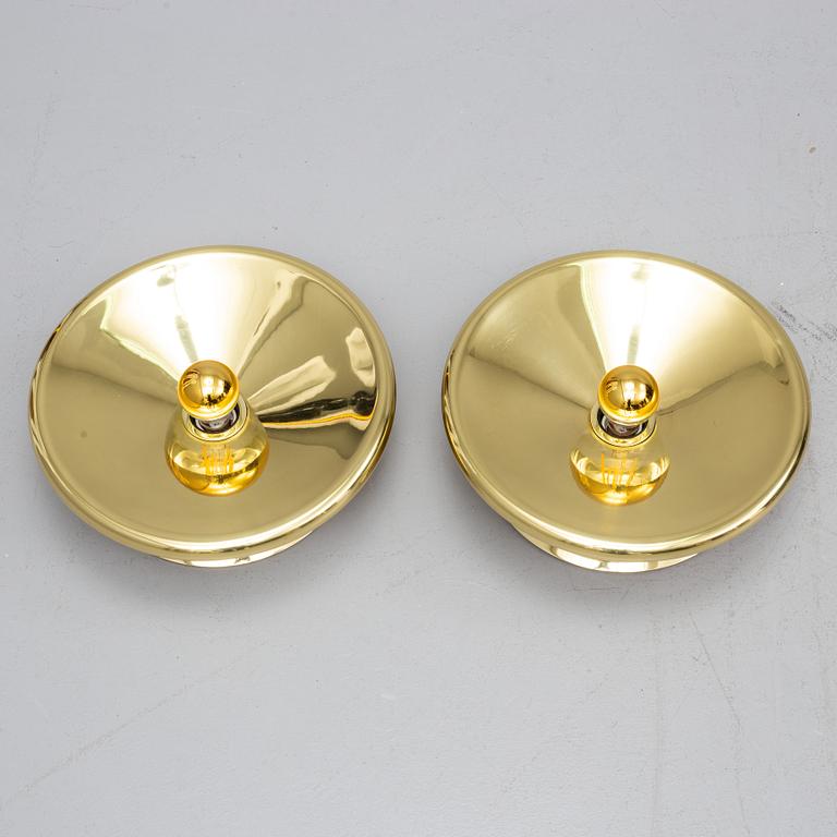 TOM DIXON, a pair of brass wall lamps.