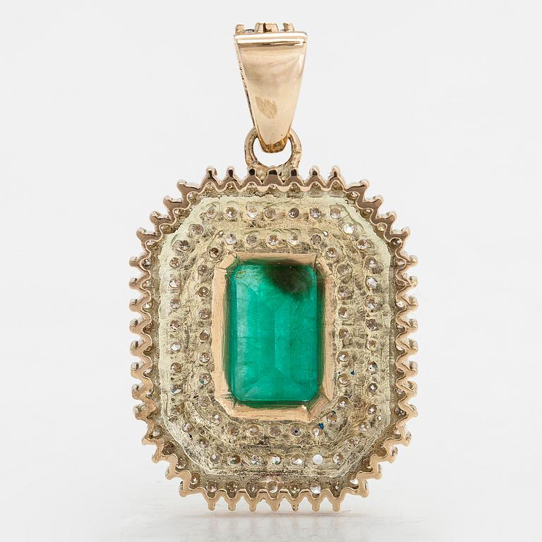 A 14K gold pendant with emerald and brilliant cut diamonds totaling approx. 0.95 ct.