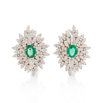 396. A pair of 18K white gold earrings set with faceted emeralds.