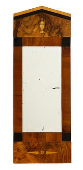 A mahogany-veneered Empire mirror, mid 19th century.