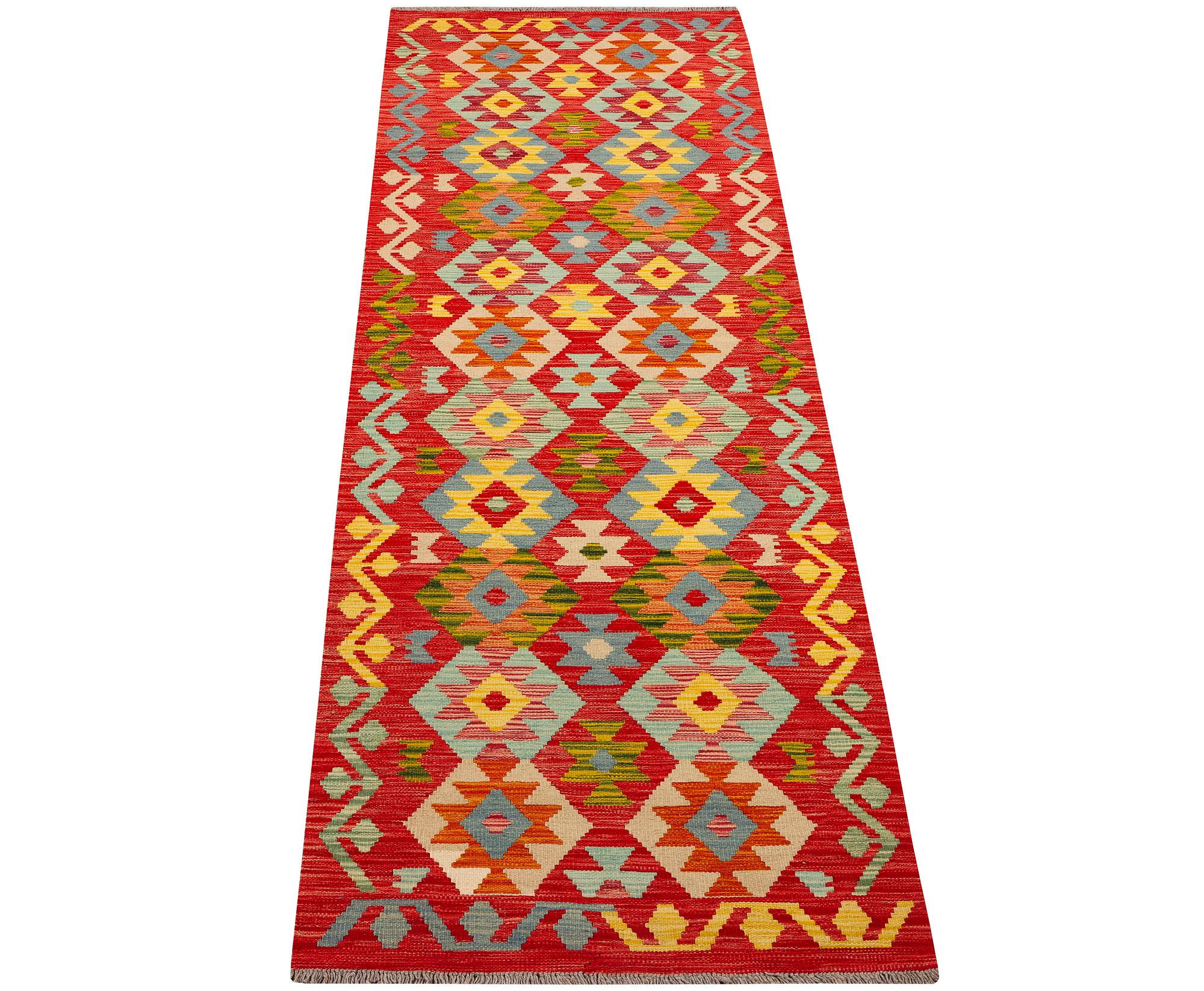 An Afghan kilim runner, c. 301 x 83 cm.