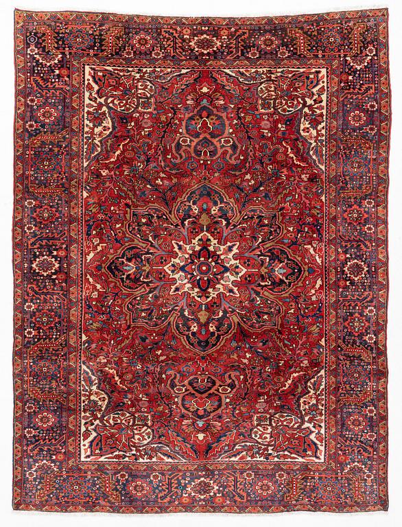 A semi-antique/old Heriz carpet, c 348 x 264 cm.
