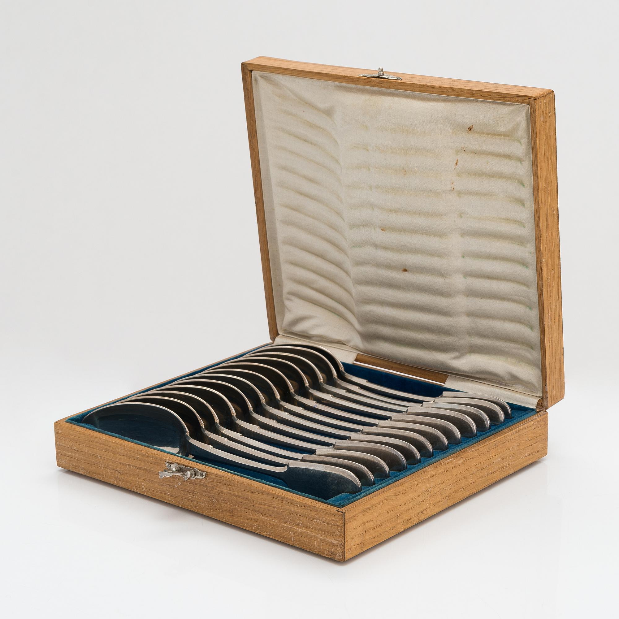 A set of 12 Morozov silver table spoons, master Adam Herttuainen. Imperial Warrant. St Petersburg 1908-17. In oak box.
