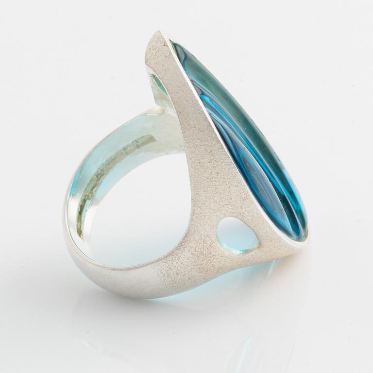 A Lapponia silver ring set with blue glass.