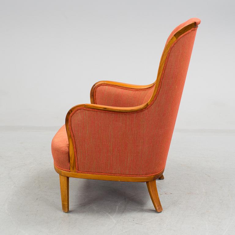 a 20h Century walnut armchair "Advokaten" designed by Carl Malmsten.