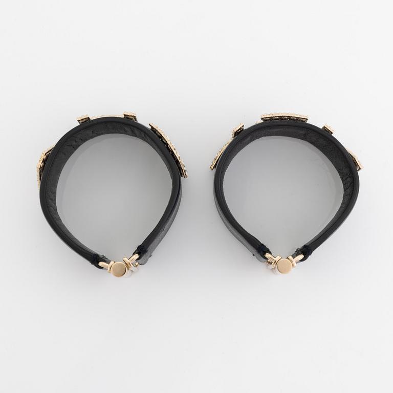 Chanel, a pair of black leather and rhinestone bracelets.