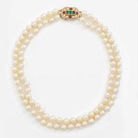 Pearl necklace, two-stranded, with a clasp by Seblings in 18K gold set with emeralds, rubies, and brilliant-cut diamonds.