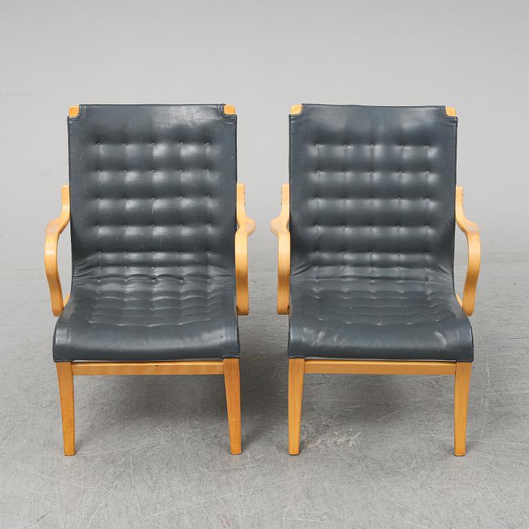 A second half of the 20th Century pair of 'Mina' armchairis by Bruno Mathsson for Mathsson International.