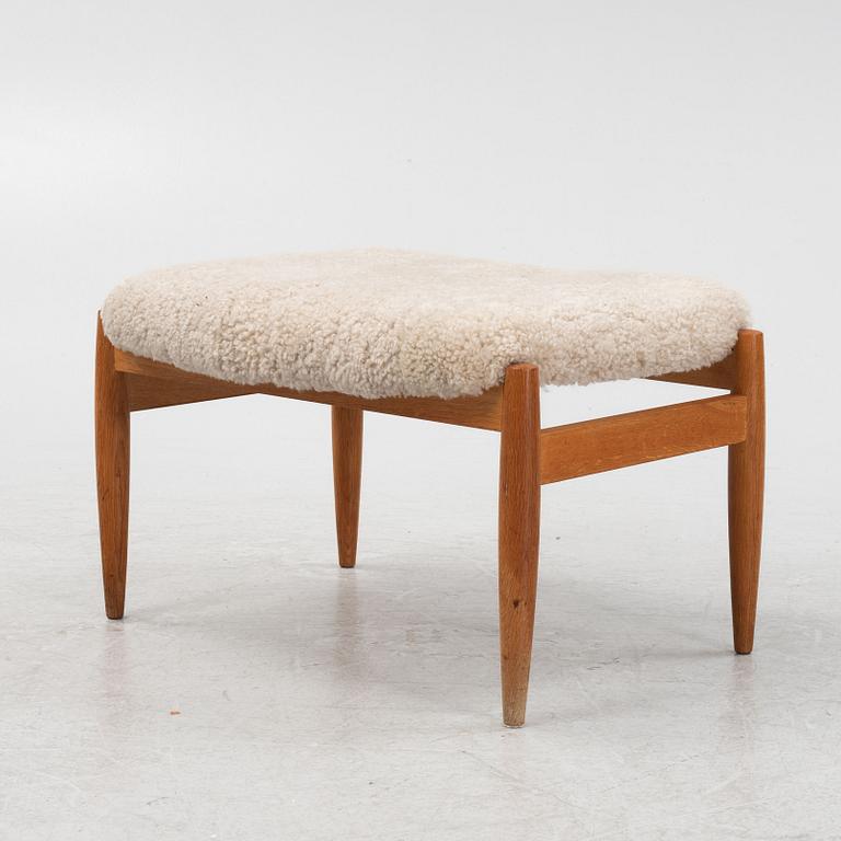 A sheepskin upholstered oak stool, second part of the 20th Century.