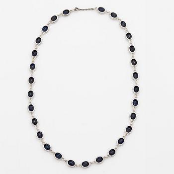 18K white gold necklace with dark sapphires.