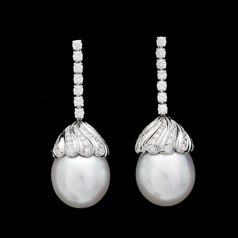 A pair of cultured South sea pearl, 14,4 mm, and brilliant cut diamond earrings, tot, app. 1.45 cts.